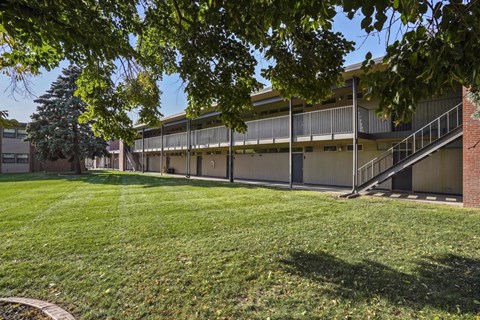 A building with a green lawn in front of it.